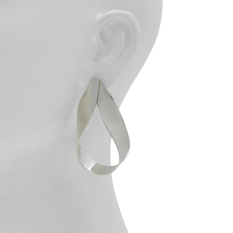 Silver twisted loop earrings on a white mannequin ear