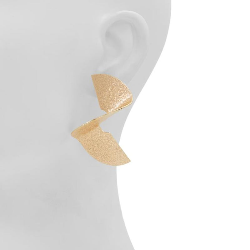 Textured gold abstract sculptural spiral earrings worn on a mannequin ear