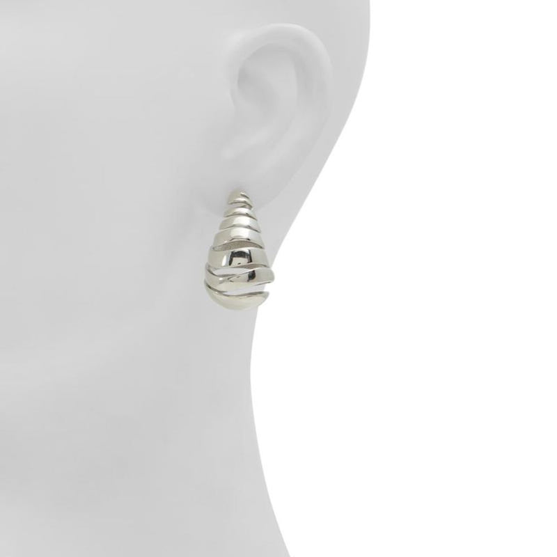 Shiny silver spiral drop earrings worn on a mannequin ear