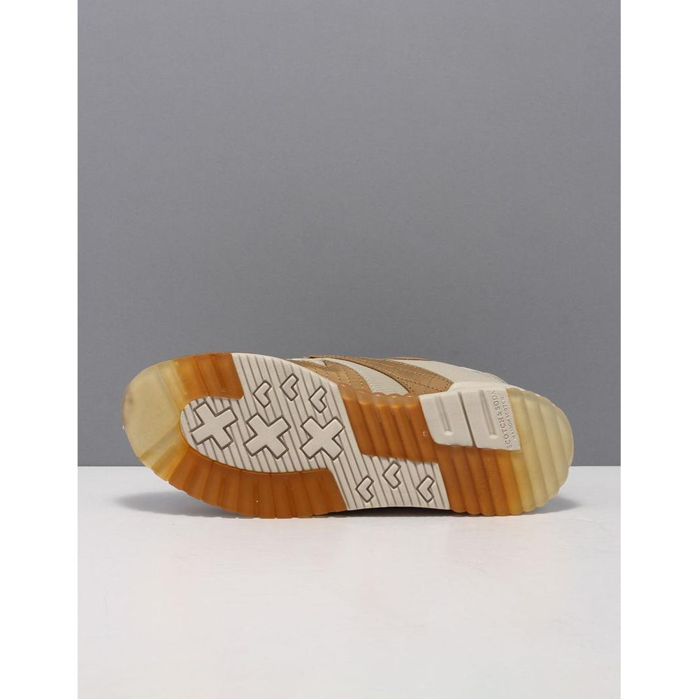 Beige Scotch & Soda low-top sneakers showing a textured gum-rubber sole with cross-shaped tread patterns.