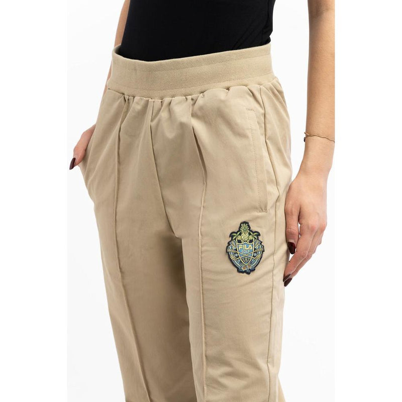 Beige cotton joggers with an elastic waistband and embroidered Fila logo patch on the thigh