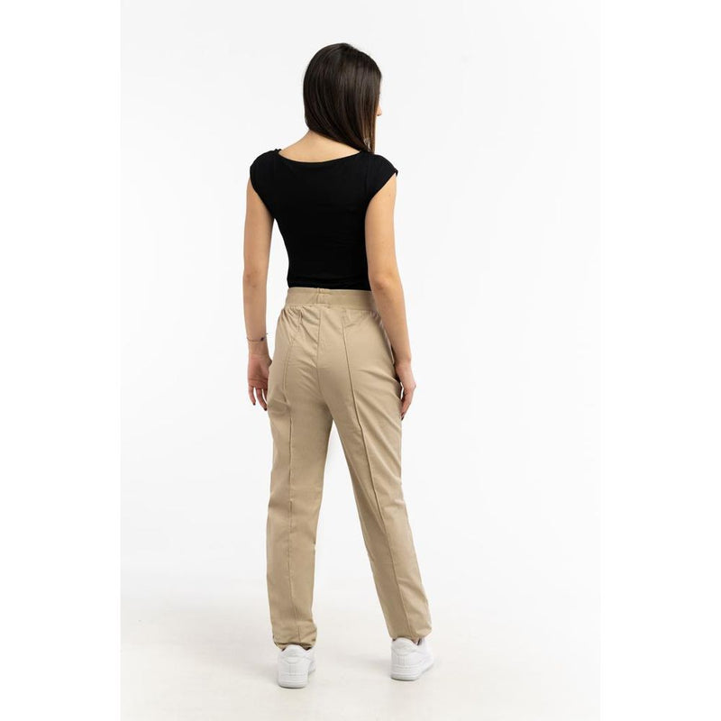 Beige cotton jogger pants with elastic waistband worn by a woman facing away