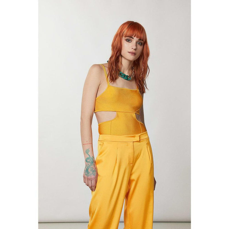 Bright orange viscose tank top with side cutouts worn by a model