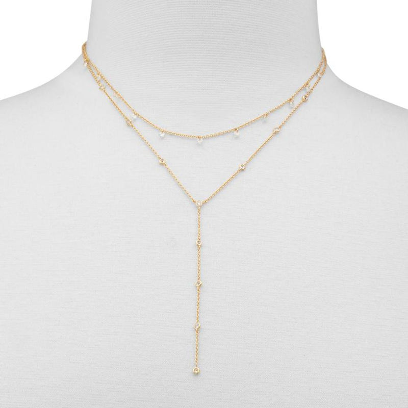 Gold layered y-necklace with crystal accents on a mannequin