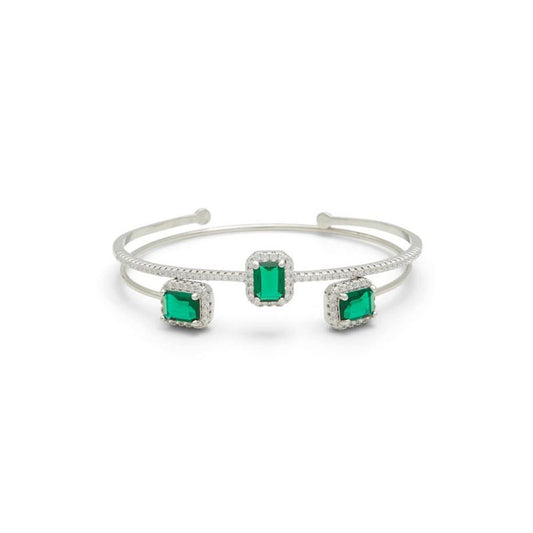 Silver metal cuff bracelet featuring three emerald-cut green stones with pavé crystal halos