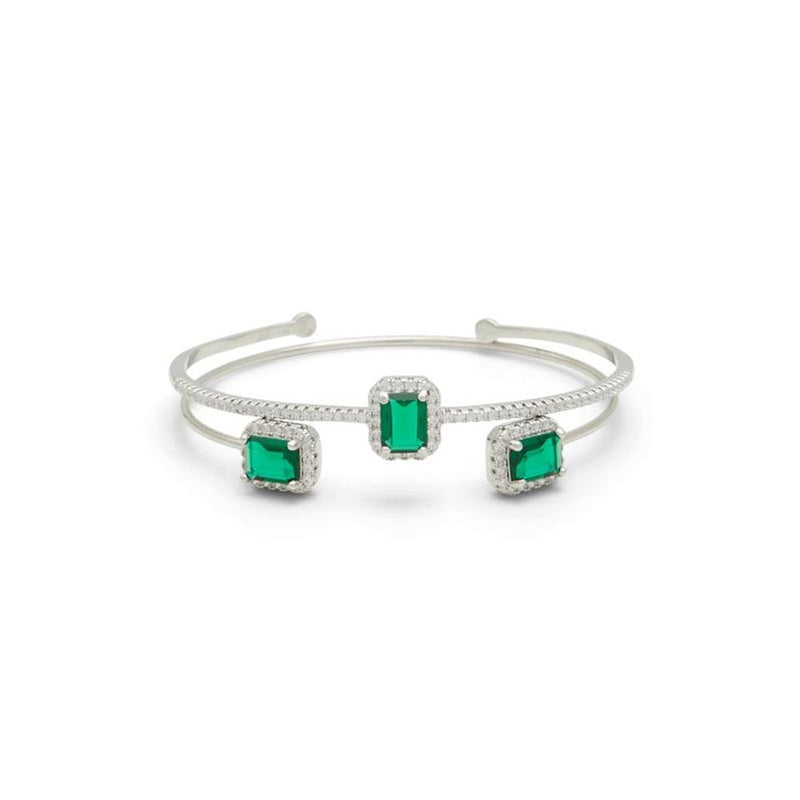 Silver metal cuff bracelet featuring three emerald-cut green stones with pavé crystal halos