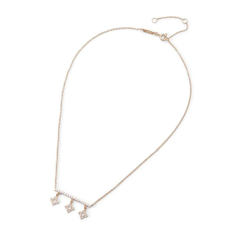 Delicate gold-tone metal chain necklace with a crystal-embellished bar and three dangling floral charms
