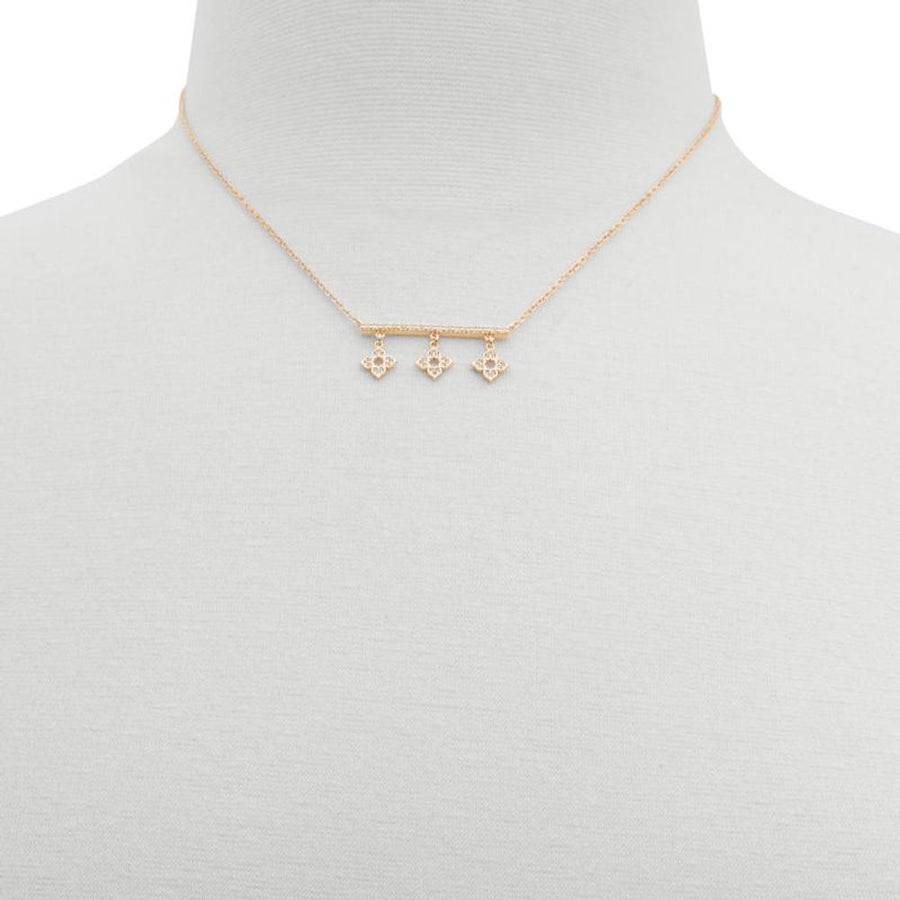 Delicate gold-tone metal chain necklace with a crystal-embellished bar and three dangling floral charms