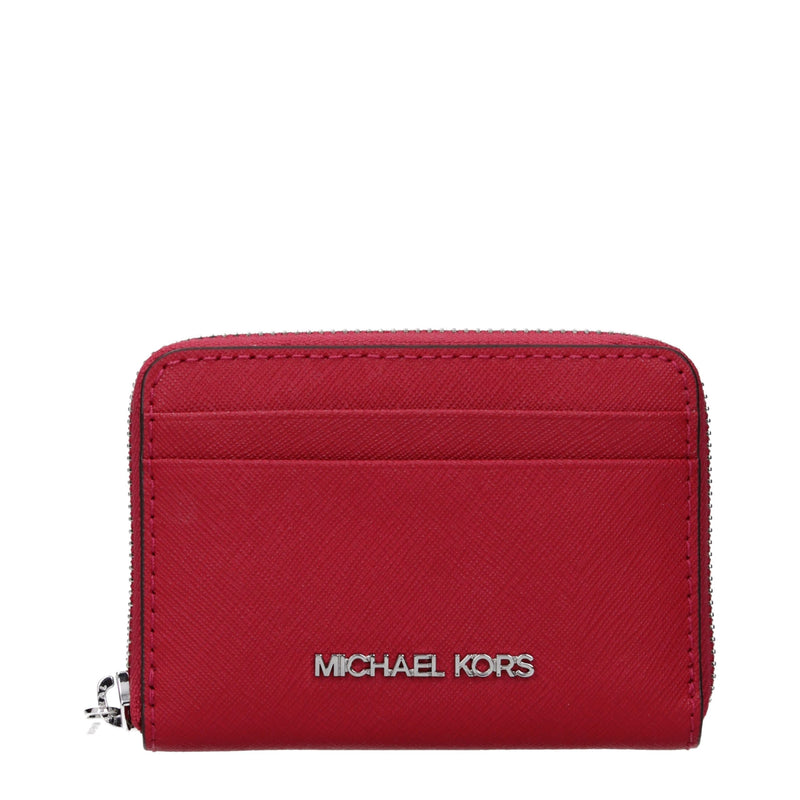 Red textured leather cardholder with a top zipper and silver Michael Kors logo on the front