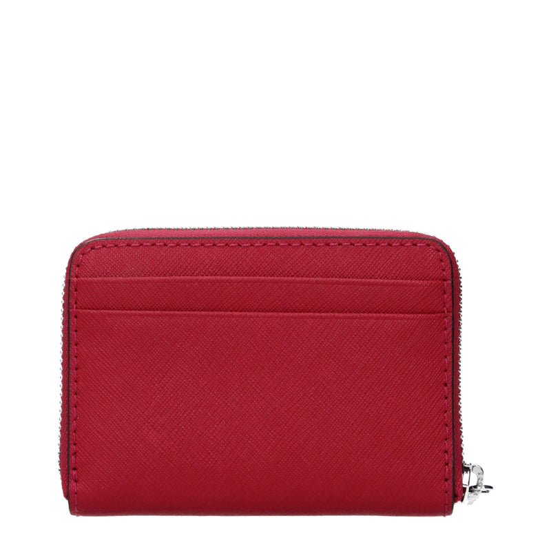 Red textured leather cardholder with a zippered coin pocket and exterior card slots