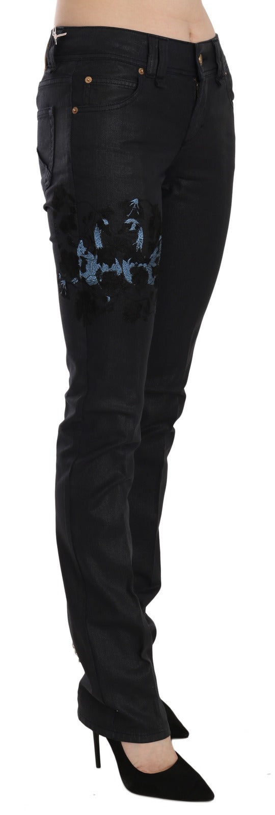 Black skinny denim jeans with mid-rise waist and blue floral embroidery on the hip