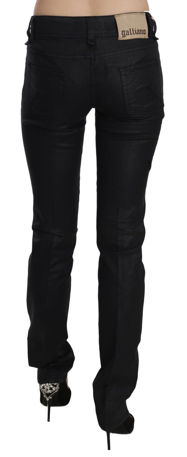 Black mid-waist skinny denim jeans from behind with a Galliano brand patch on the back waistband
