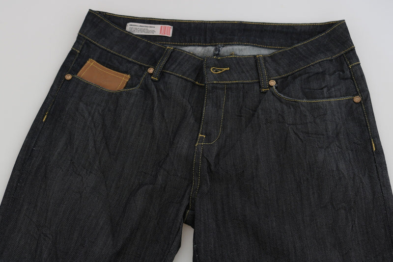 Dark blue denim high-waist straight jeans with contrast stitching and brown leather pocket detail