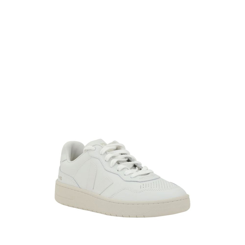 White low top sneaker with perforated toe and beige rubber sole