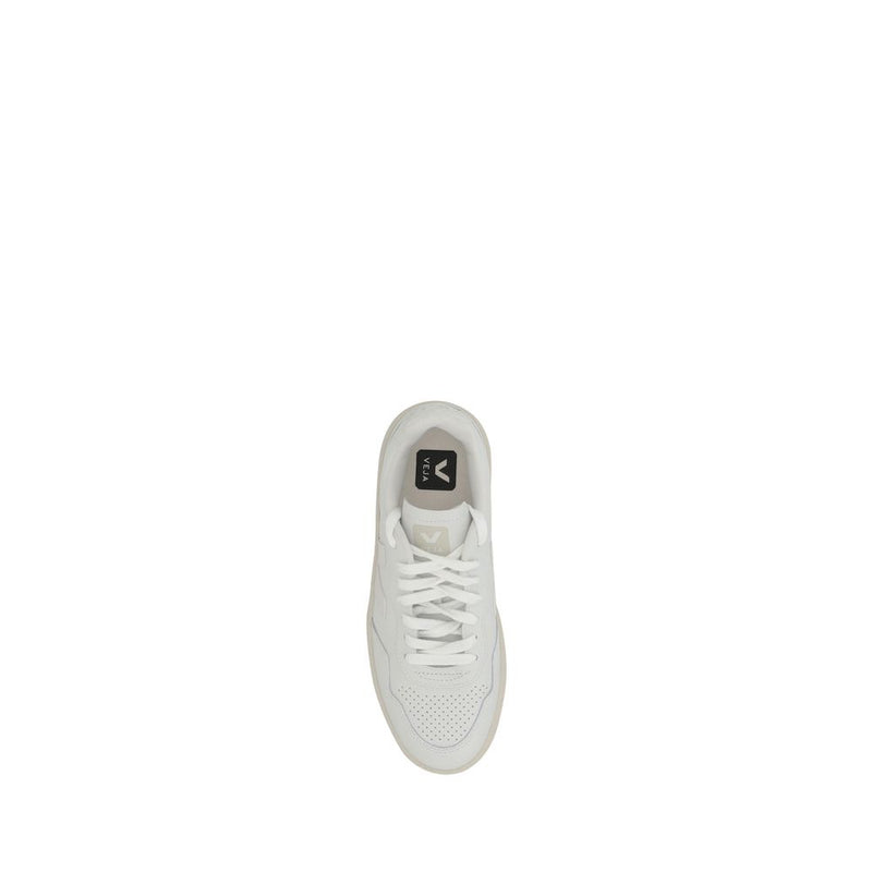 Top-down view of a white low-top sneaker with laces and perforated toe detail