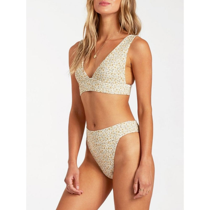 Beige floral polyester bikini set featuring a v-neck top and high-cut bottoms worn by a model