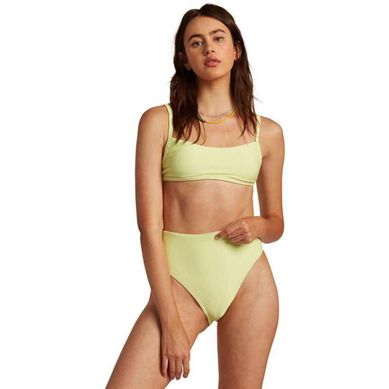 Model wearing a light yellow two-piece bikini with a ribbed texture