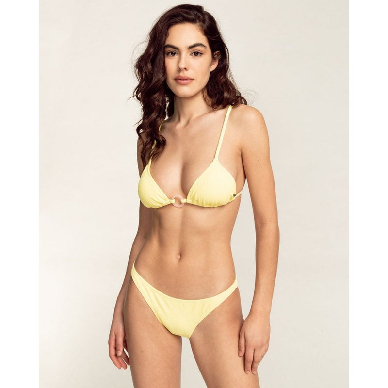 Model wearing a pale yellow ribbed bikini set with a center ring detail