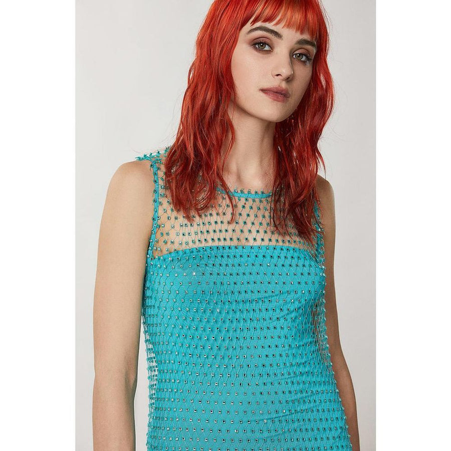 Turquoise mesh polyester dress with rhinestone pattern layered under a matching blazer