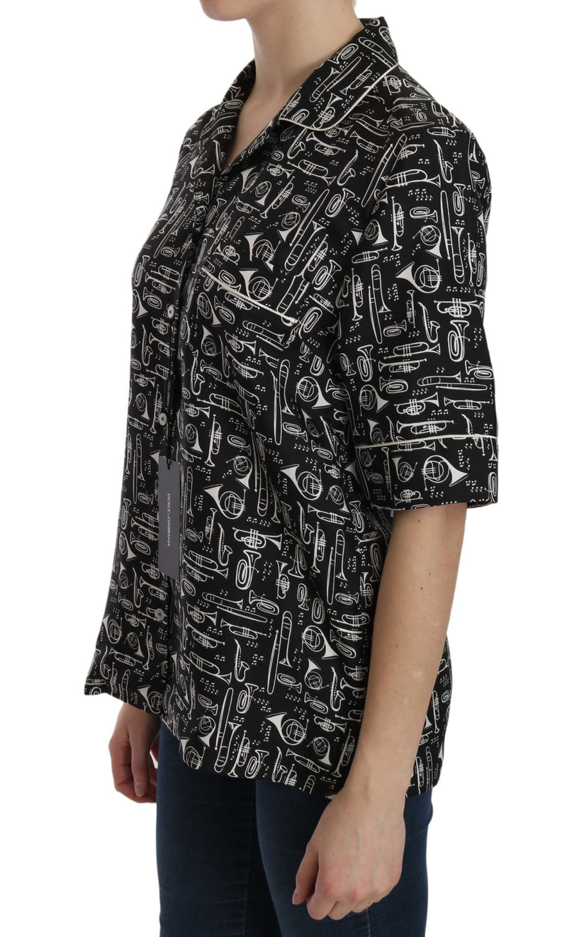Black silk top with white musical instrument print, short sleeves and collar