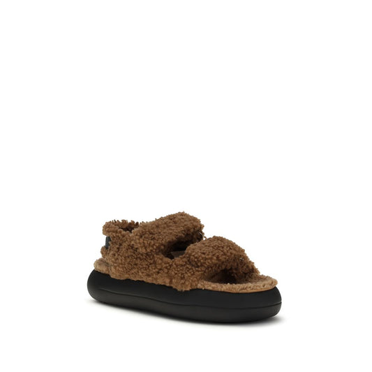 Brown faux-shearling double-strap slide sandals with a chunky black rubber platform sole by Moon Boot.