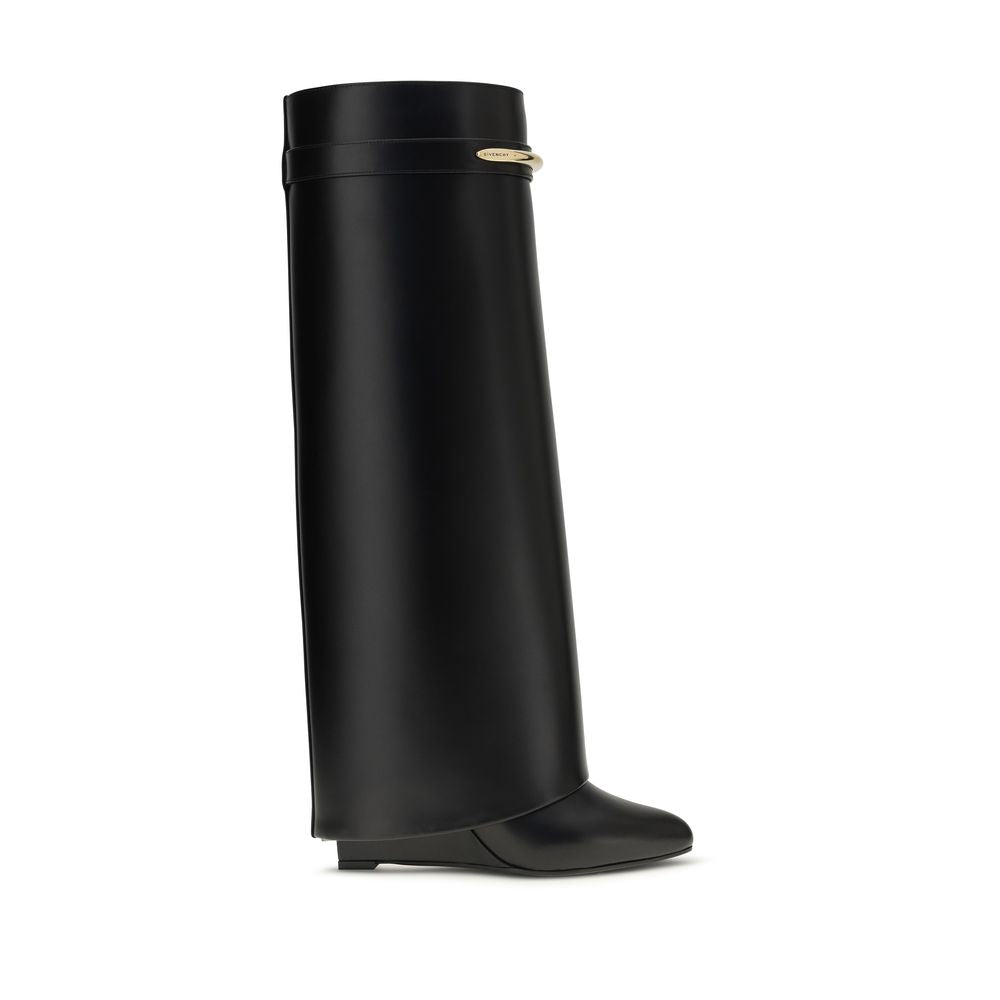 Black leather knee-high boot with a structured, wide-leg cuff and a gold-tone metallic hardware detail.