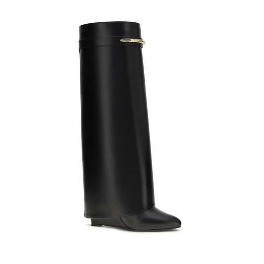 Black Givenchy Shark Lock leather knee-high boot with a wedge heel and gold-tone metal band accent.