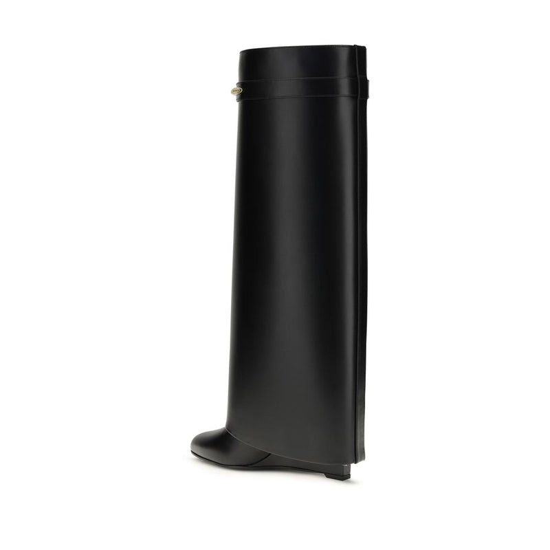 Black knee-high leather boot with a wide shaft, structured silhouette, and a small wedge heel.