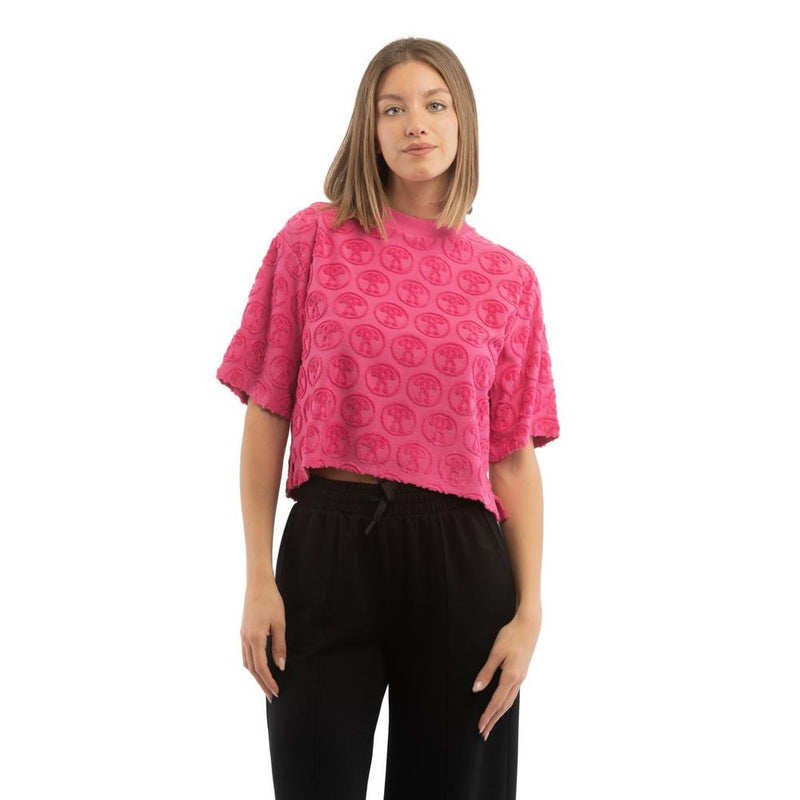 Fuchsia pink cotton t-shirt with textured circular logo pattern, short sleeves, and raw hem