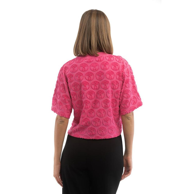 Fuchsia pink cotton t-shirt with textured circular logo pattern viewed from the back
