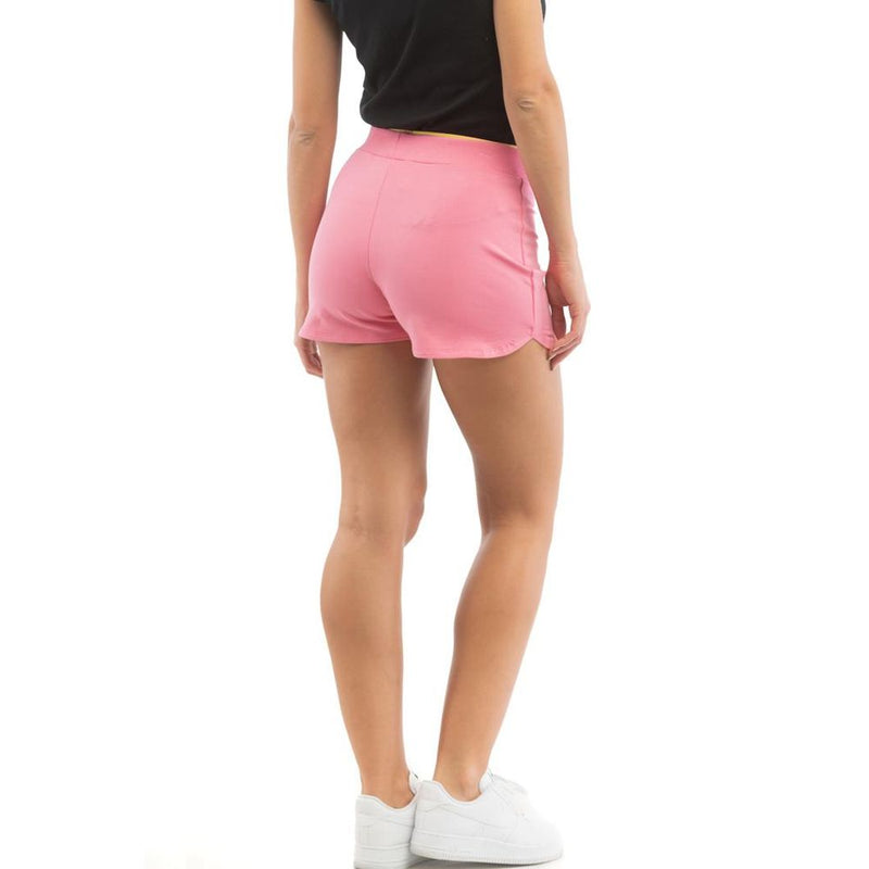 Pink cotton mini shorts worn by a woman viewed from behind