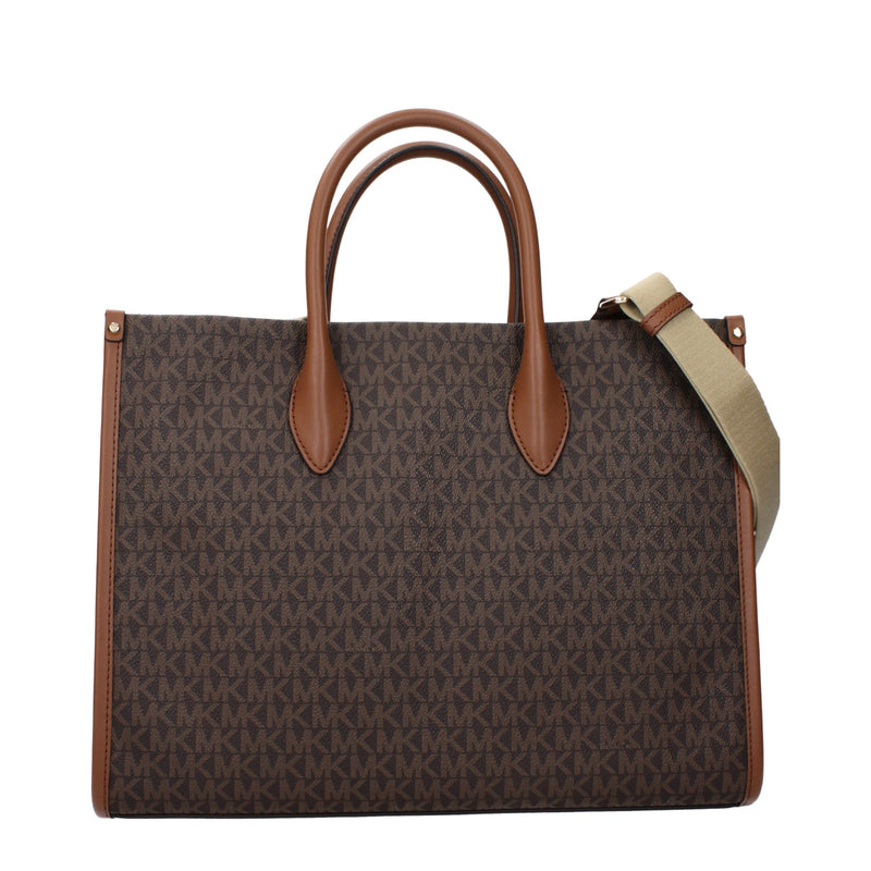 Brown canvas Michael Kors tote handbag with a monogram pattern and brown leather handles