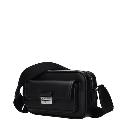 Black leather Michael Kors crossbody bag with a front flap pocket and silver hardware