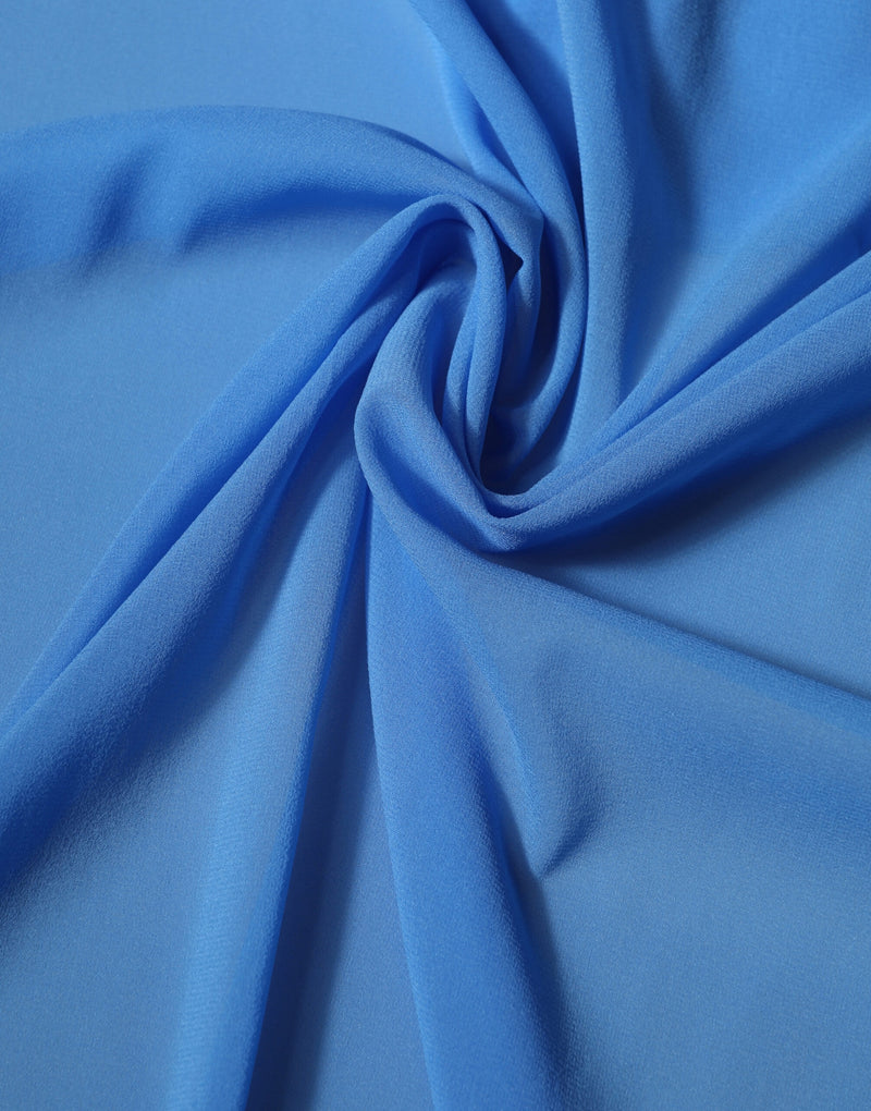 Bright blue silk scarf artfully draped in soft swirls