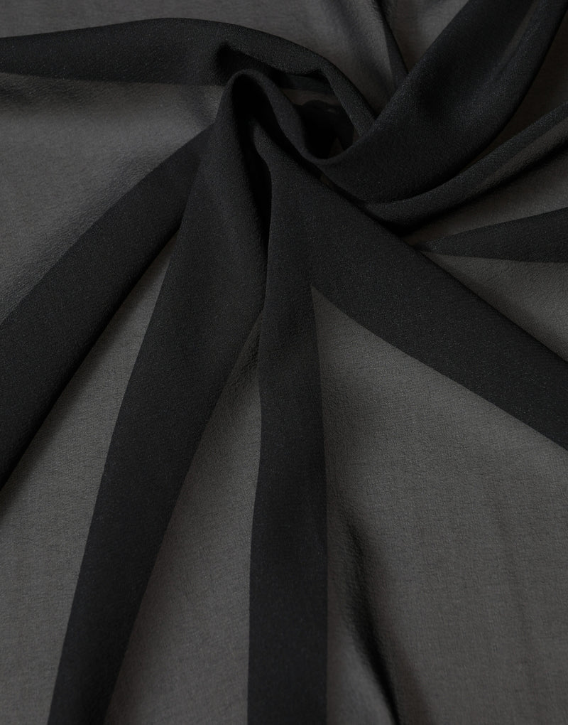 Black silk scarf draped in soft folds