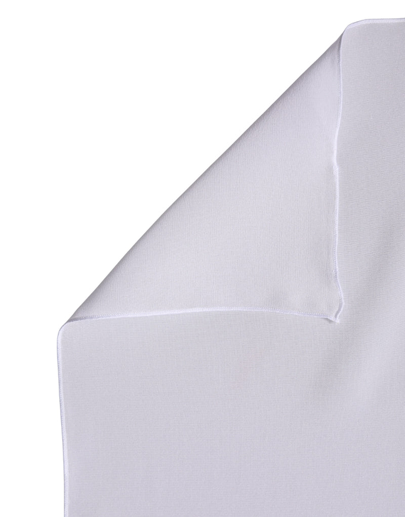 White silk scarf folded over to show its smooth texture and finished edge