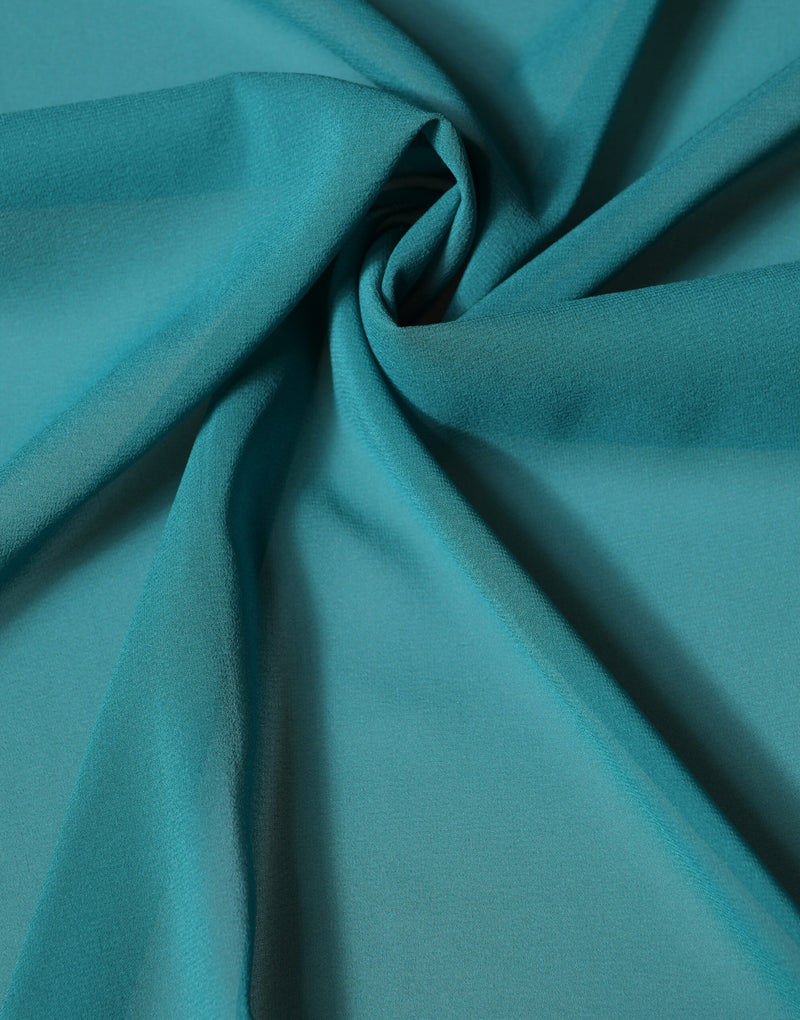 Blue-green silk chiffon scarf arranged in soft draped folds