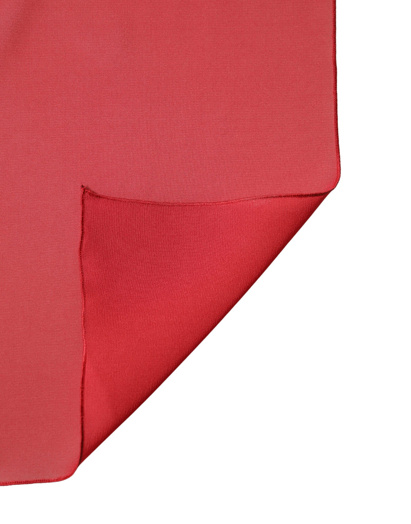 Red silk shawl draped with a folded corner revealing a smooth texture