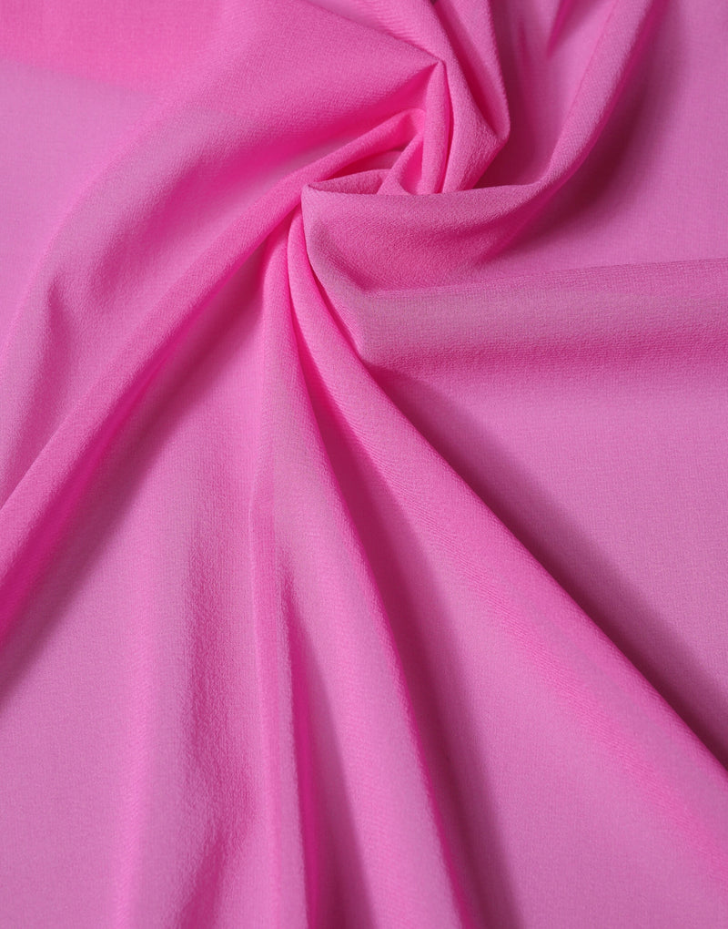 Bright pink silk shawl draped in soft folds showcasing the smooth fabric texture