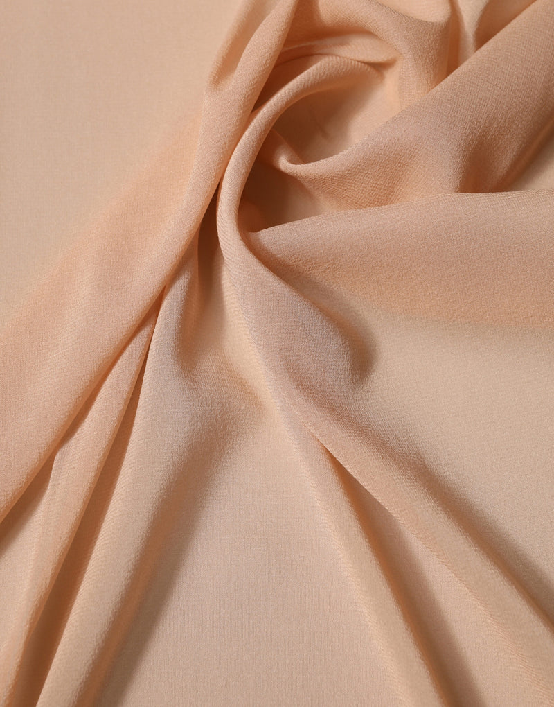 Luxurious beige silk scarf draped in soft folds
