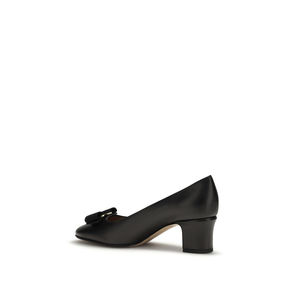 Ferragamo black calf leather mid-heel pump with a rounded toe, block heel, and signature bow detail.
