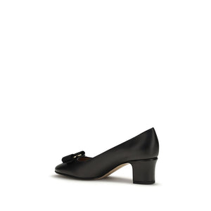Ferragamo black calf leather mid-heel pump with a rounded toe, block heel, and signature bow detail.