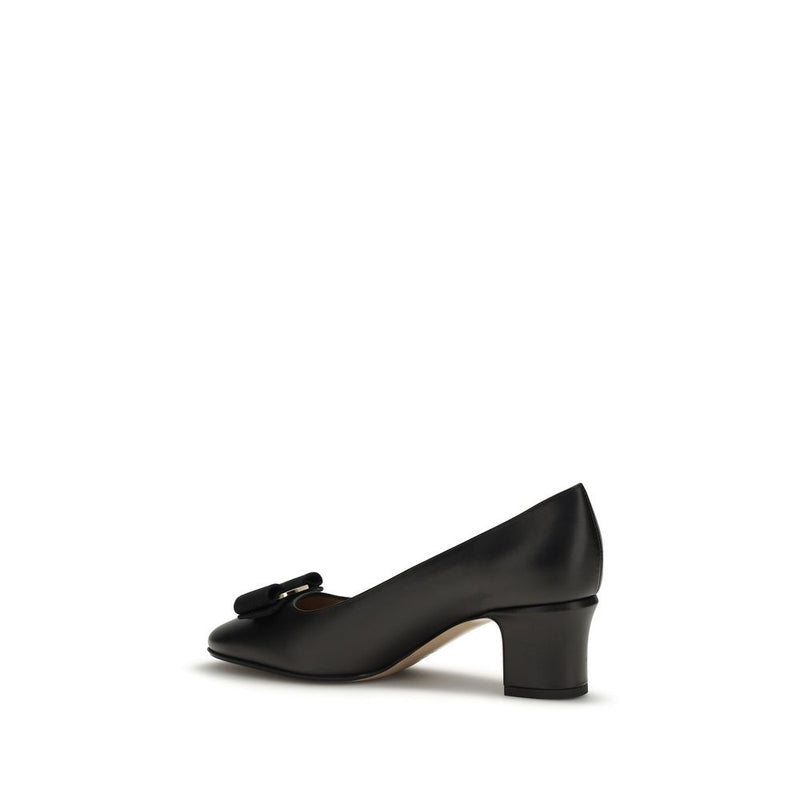 Ferragamo black calf leather mid-heel pump with a rounded toe, block heel, and signature bow detail.