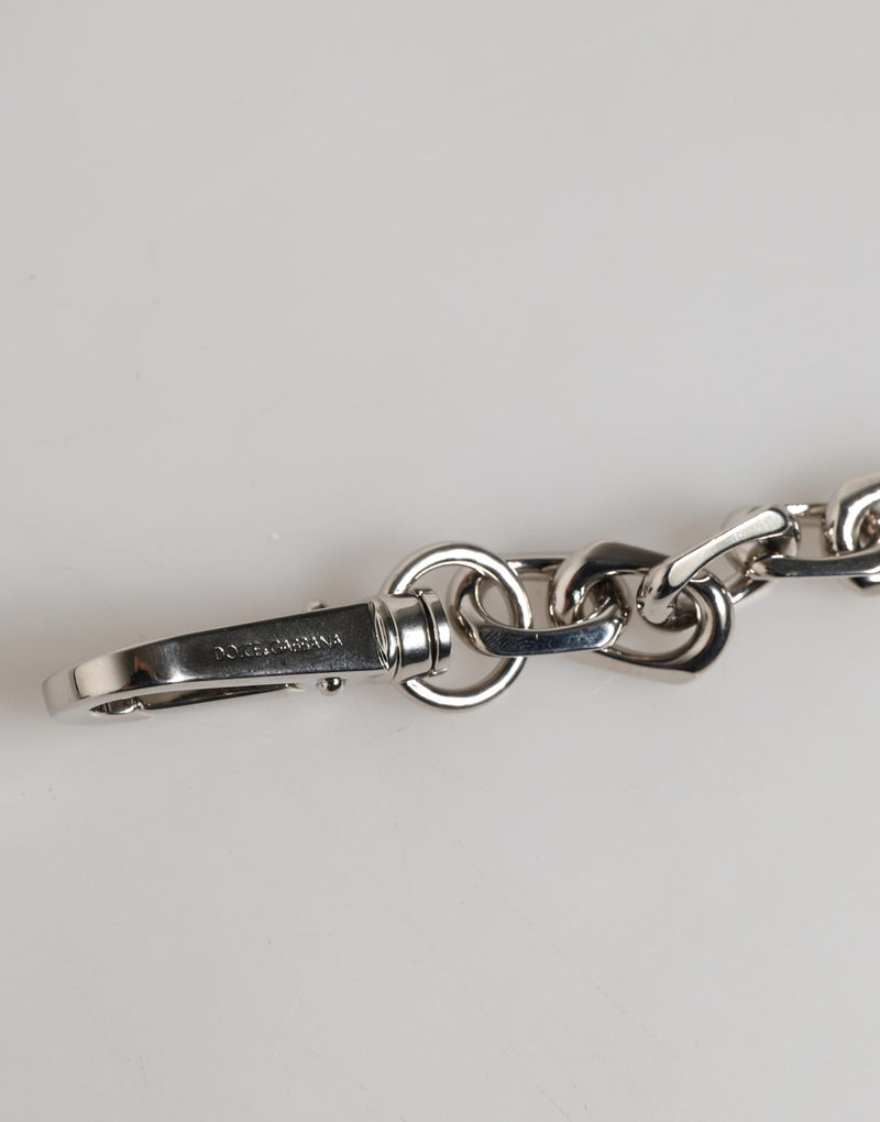 Silver tone metal lobster clasp and chain link bracelet with engraved logo