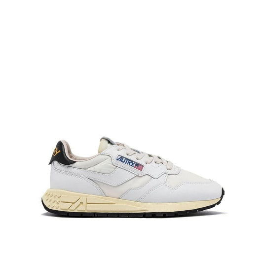 Autry white fabric and leather athletic sneaker with off-white midsole, black heel tab, and branded side label.
