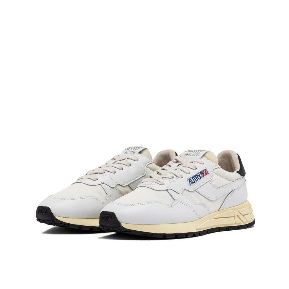 Autry white fabric and leather athletic sneakers with off-white midsoles and black rubber outsoles.