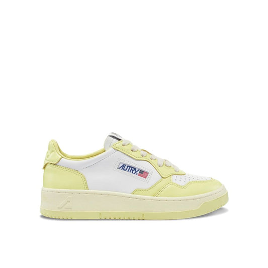 Autry white and pastel yellow leather low-top sneakers with a flat rubber sole and signature brand logo patch.