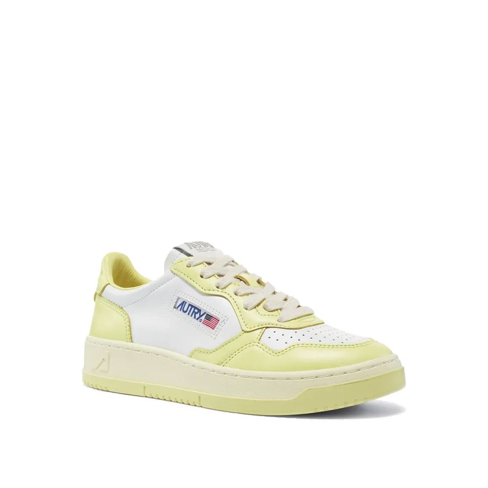 Autry low-top sneakers in white and pastel yellow leather with a lace-up front and a branded side tag.