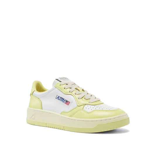 Autry low-top sneakers in white and pastel yellow leather with a lace-up front and a branded side tag.