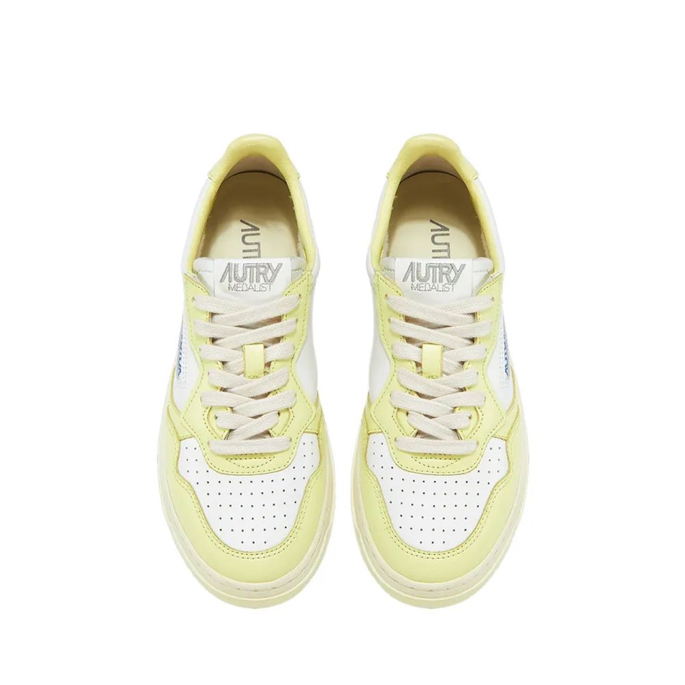 Autry white and pale yellow leather low-top sneakers with lace-up front and perforated toe box.